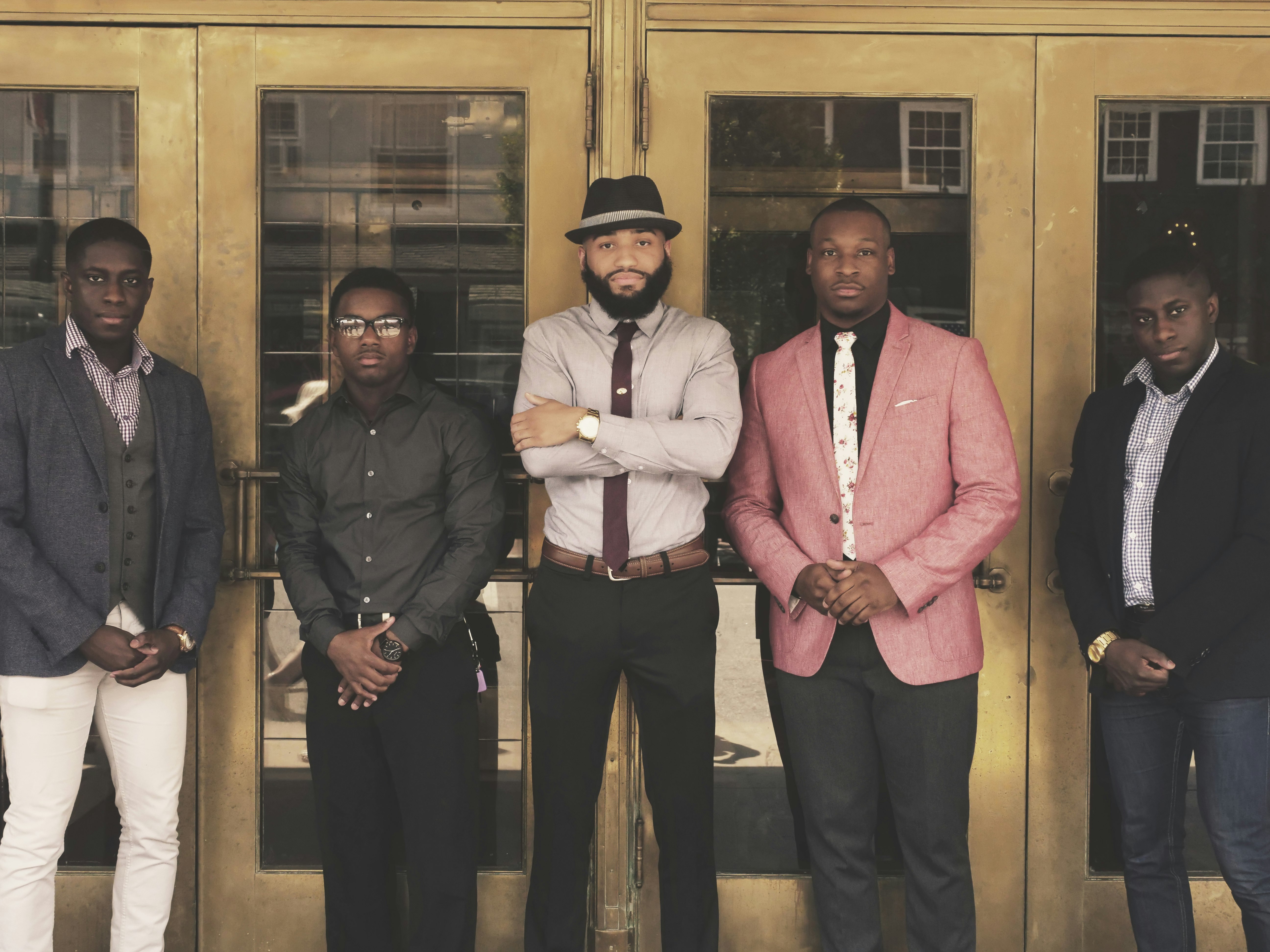 A group of well dressed dark skinned men.